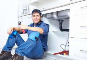 Dale City plumbing contractor rests while installing a kitchen sink